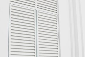 white wooden louvered door