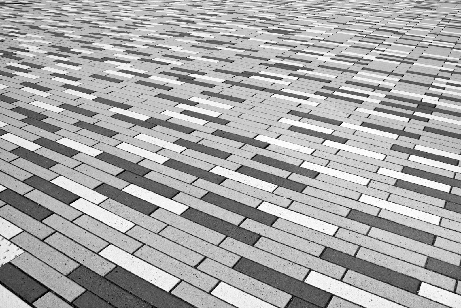 Abstract black and white patterned brick floor provides a geometric visual effect.