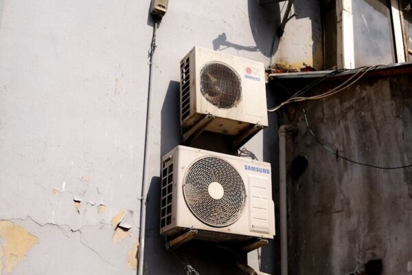 a group of white and black satellite dishes on a white building